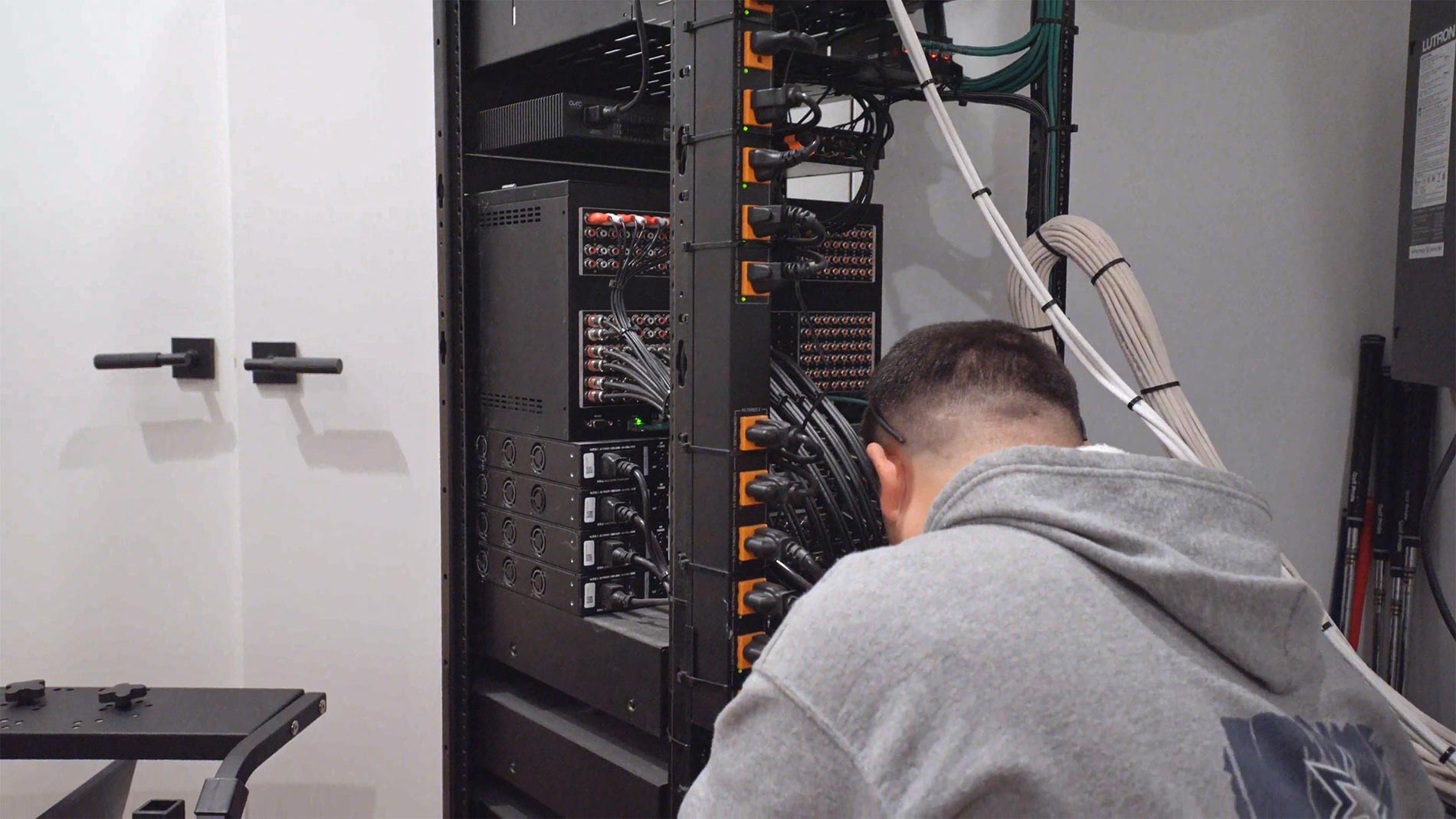 Technician organizing and connecting cables in a professional server rack
